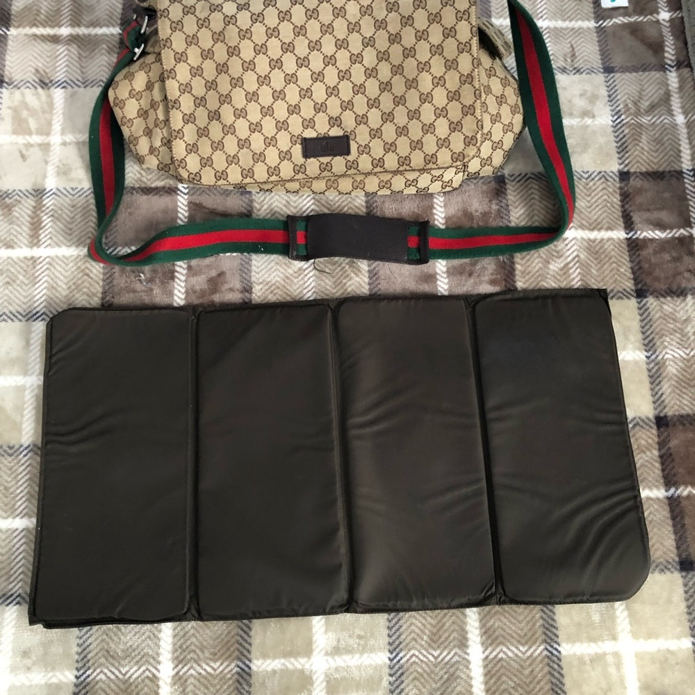 Gucci canvas diaper bag, with multiple pockets and fold-out changing pad